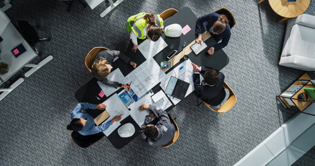 Aufkleber - Top Down View of Diverse Team of Real Estate Construction Engineers Working With Blueprints and Documents in an Office. Workspace Of Housing Development Company with Business Managers and Architects