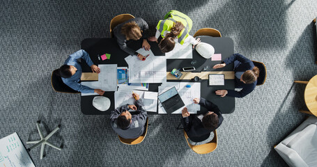 Aufkleber - Top Down View of Diverse Team of Real Estate Construction Engineers Discussing Project Blueprints in an Office. Architectural Bureau With Colleagues Using Tablet, Laptop, Wearing Reflective Jacket.