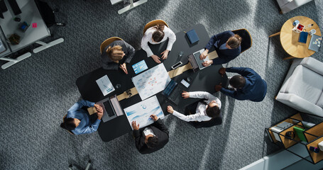 Aufkleber - Diverse Professionals Working on Business Statistics Reports and Digital Plans in an Office. Top Down View of Discussion and Data Analysis on Laptops and Charts. Teamwork and Innovation Concept