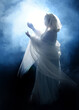 © faestock - full length portrait beautiful blonde fantasy maiden faery wearing medieval fairytale ballgown costume, veiled white hooded cape. standing pose  isolated dark studio background with smoky fog effect
