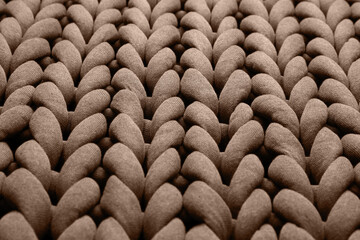 Wall Mural - Knitted fabric in mocha mousse shade, closeup. Trendy color of 2025 year