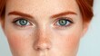 © KN Studio - Intriguing Gaze: Close-up portrait of a young woman with captivating green eyes and freckled skin, capturing a sense of innocence and wonder.