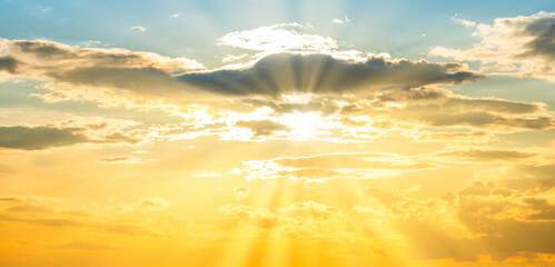 Wall Mural - Sunset sky panorama background with sun and sunset clouds