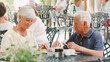 © Monkey Business - Senior Retired Couple Sitting At Table Enjoying Meal At Outdoor Cafe Or Restaurant