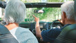 © Monkey Business - Rear View Of Senior Couple On Road Trip In Convertible Car Driving Along Tree Lined Road