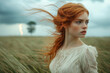 © lirida - portrait of a woman with red hair,Young woman with red hair stands in a field under a stormy sky while lightning strikes in the distance