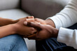 © Siasart Stock - Close-up of Two People Holding Hands with Empathy and Support in Comforting Gesture