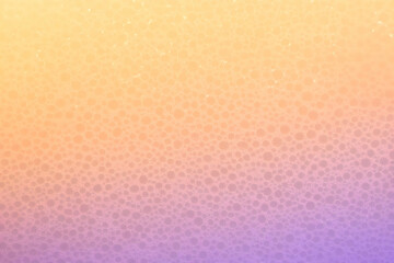Close-up of a porous material with a gradient of orange and purple colors creates a unique texture.