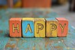 © Michael - Colorful wooden alphabet blocks spelling the word happy on a rustic wooden surface