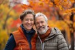 © Markus Schröder - Portrait of a joyful couple in their 40s dressed in a breathable mesh vest in background of autumn leaves