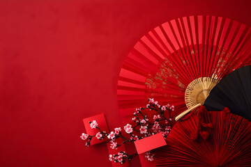 Wall Mural - Chinese New Year celebration concept with red envelopes, paper fans, cherry blossoms on red background