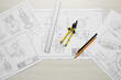© New Africa - Different engineering drawings, pencils, ruler and divider on wooden table, flat lay