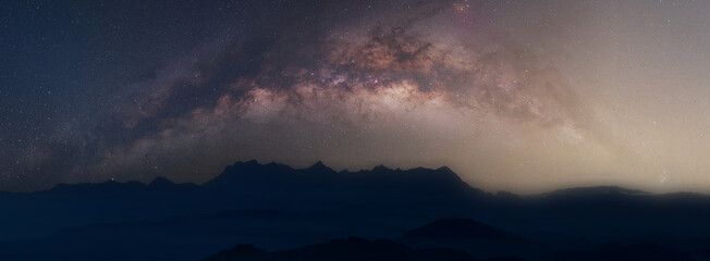 Wall Mural - universe space and milky way galaxy with stars on night sky mountain background. milky way galaxy mo