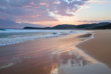 Aufkleber - Sunset over calm ocean waves at a serene beach with soft pink and blue sky colors during the twilight hours of the evening