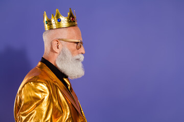 Profile portrait of funny eccentric aged man empty space wear golden shiny suit isolated on purple color background