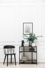 Poster - Console table with decor and chair near white wall in room. Interior design