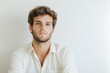 © J. Grayscale - Confident Young Man with Stylish Hair Posing Against a Neutral Background