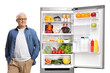 © Ljupco Smokovski - Mature man with a grocery bag posing with a fridge