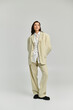 © LIGHTFIELD STUDIOS - A beautiful young woman stands confidently in a chic, oversized suit, exuding fashion vibes.