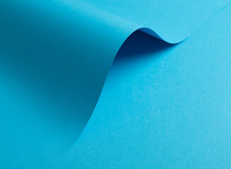 Wall Mural - blue paper background with a smooth matte finish and soft shadows. vibrant pastel tones and a subtle