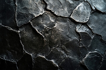 Poster - Dark, textured stone surface with irregular, fragmented shapes and deep shadows.