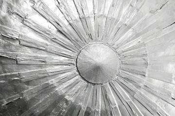 Poster - Silver sunburst design with radiating lines and textured surface, creating a striking visual effect.