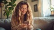 © Olena - Happy woman reading text message on mobile phone at home.