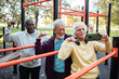 © Marko Geber - Senior men flexing muscles at outdoor park gym