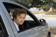 © Natalia Navodnaia - blond male driver sitting in car behind wheel on right