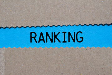 Wall Mural - Ranking message written on ripped torn paper on blue background. Conceptual ranking symbol. Copy space.