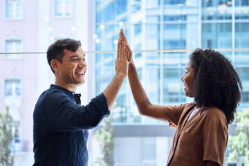 Wall Mural - two happy diverse young team business people colleagues man and woman employees giving high five sta