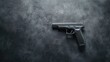 © khonkangrua - Black handgun on textured surface showcasing sleek design and modern craftsmanship in a minimalist setting