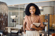 © insta_photos - Happy confident young successful African American business woman lawyer, female advisor, company executive or entrepreneur standing in corporate work office holding digital tablet. Portrait.