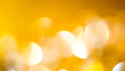 Wall Mural - gold background. golden holiday glowing backdrop. defocused background with blinking stars. blurred 