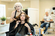 © JackF - Young girl is satisfied with her new hairstyle after having her hair cut by a professional female hairdresser