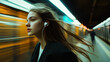 © 沈军 贡 - A young woman with long hair, wearing earphones and headphones, stands on the subway platform in while waiting for her train to go home