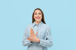 © Pixel-Shot - Young deaf mute woman using sign language on blue background