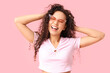 © Pixel-Shot - Beautiful happy African-American woman with sunglasses on pink background