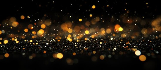 Wall Mural - golden bokeh lights on black background with sparkling dust particles and copy space for text placem