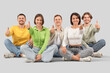 © Pixel-Shot - Group of young people in jeans showing thumbs-up on light background
