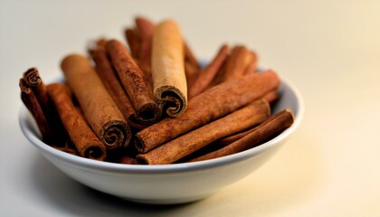 Wall Mural - Warm-toned cinnamon sticks in a bowl. Aromatic and inviting.