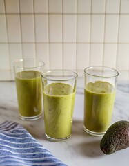 Canvas Print - Three glasses of refreshing green smoothie.  Perfect for a healthy start!