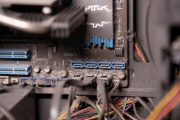 close-up of a dusty computer motherboard with visible sata ports and cables, highlighting neglect an
