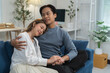 © crizzystudio - Young asian couple relaxing and dreaming together on the sofa in the living room, enjoying a quiet moment of affection and intimacy in their new home