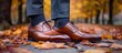 © U.D.I.N - Autumnal Elegance: Polished Brown Oxfords Amidst Fallen Leaves