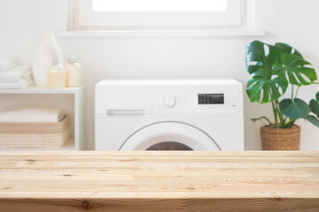 Wall Mural - empty wooden table mockup for design in blurred laundry room