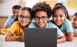 © Govindan maruthai - Cheerful Black Schoolboy Learning Online with Diverse Classmates in a Modern Classroom – Embracing E-Learning and Education Technology