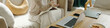 © DragonImages - Individual sitting on cozy couch writing notes in a journal using comfortable pillows for support, laptop and snacks nearby providing resources and comfort while relaxing in warm surroundings