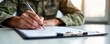 © Pete - Military person fills out form for financial assistance program. Veteran applying for loan repayment support. Financial relief opportunities for military members. Document signing for debt
