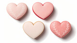 This image showcases a close-up arrangement of four heart-shaped cookies or biscuits on a white background. andy